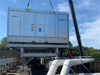 Mechanical unit being lowered by a crane