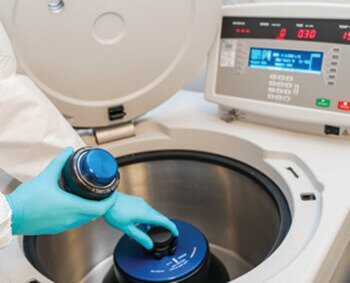worker using biomedical equipment in a laboratory